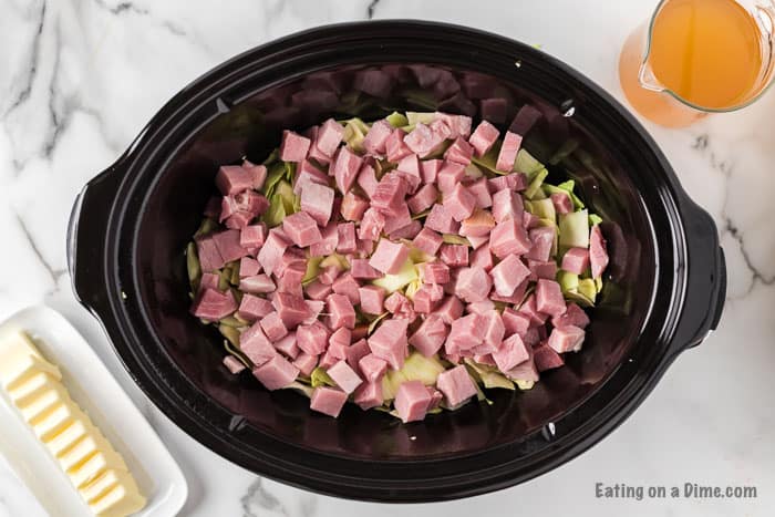 Shredded cabbage and diced ham in the slow cooker