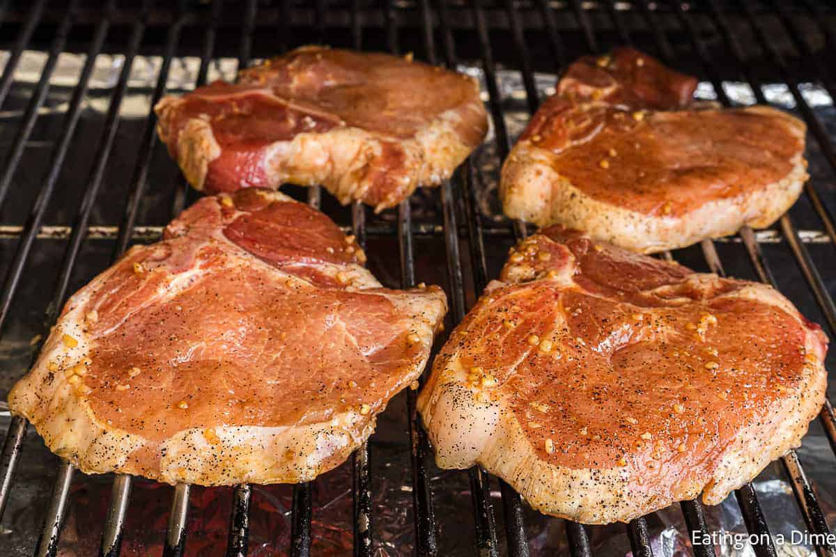 Placing the pork chops on the grill