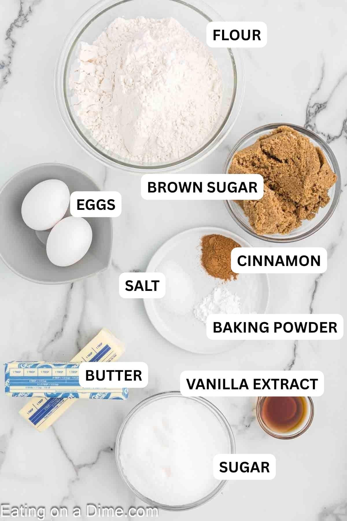 Ingredients prepared on the countertop. Includes butter, brown sugar, sugar, eggs, vanilla extract, flour, baking powder, cinnamon and salt.