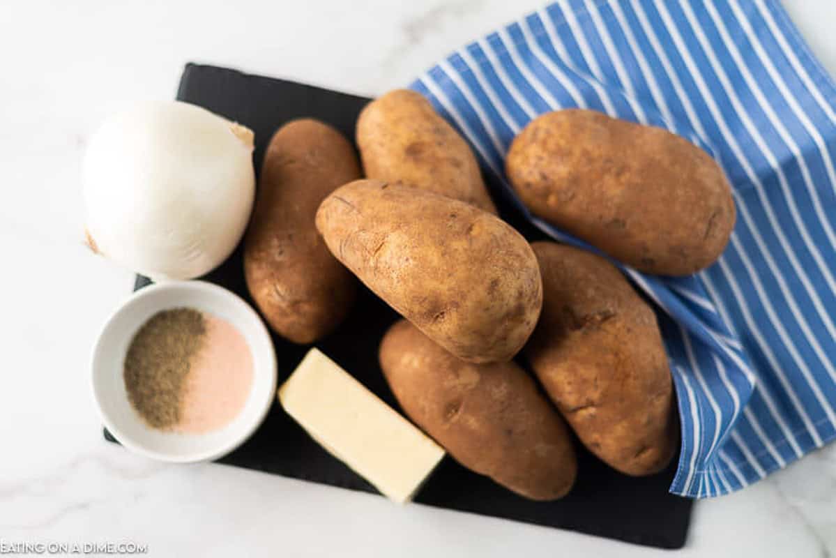 Grilled potatoes in foil ingredients - potatoes, butter, onion and seasoning