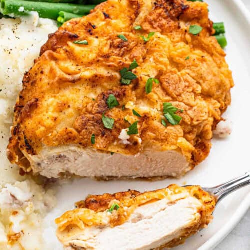 Chicken cutlet with mashed potatoes and green beans.