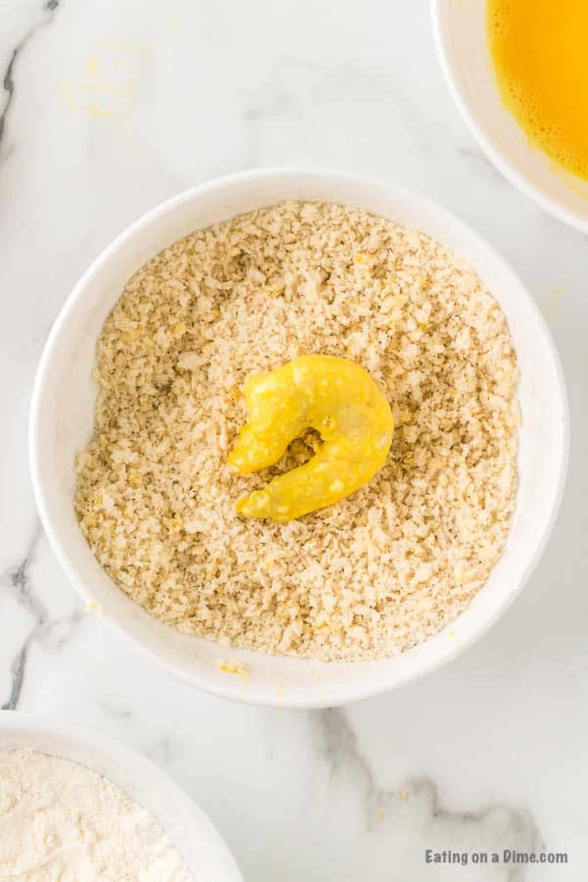 Dipping the eggs in the breadcrumbs