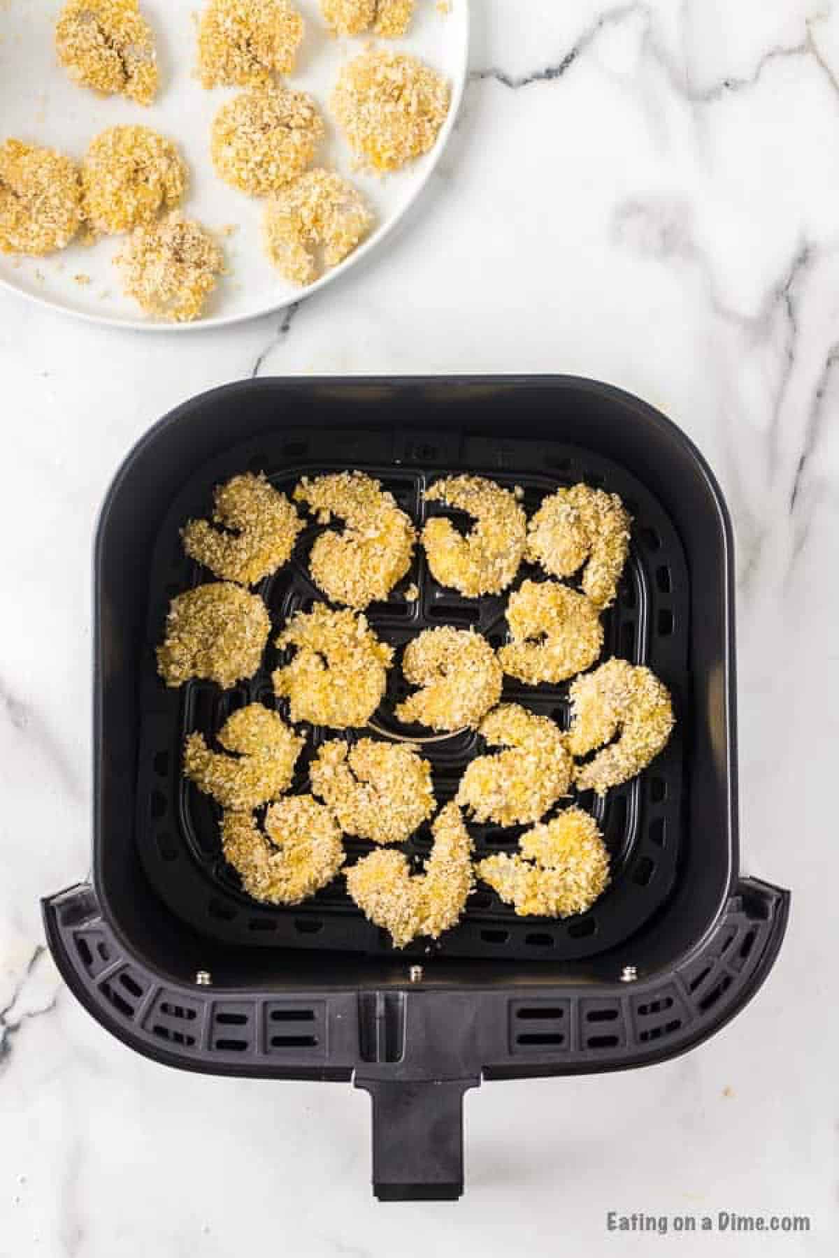 Breaded shrimp in the air fryer basket