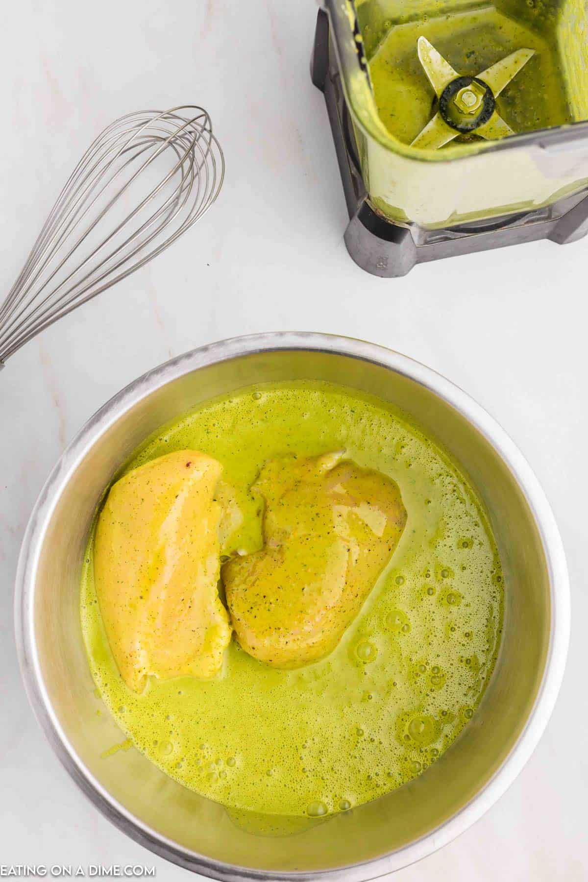 Placing the chicken in the marinade in a bowl