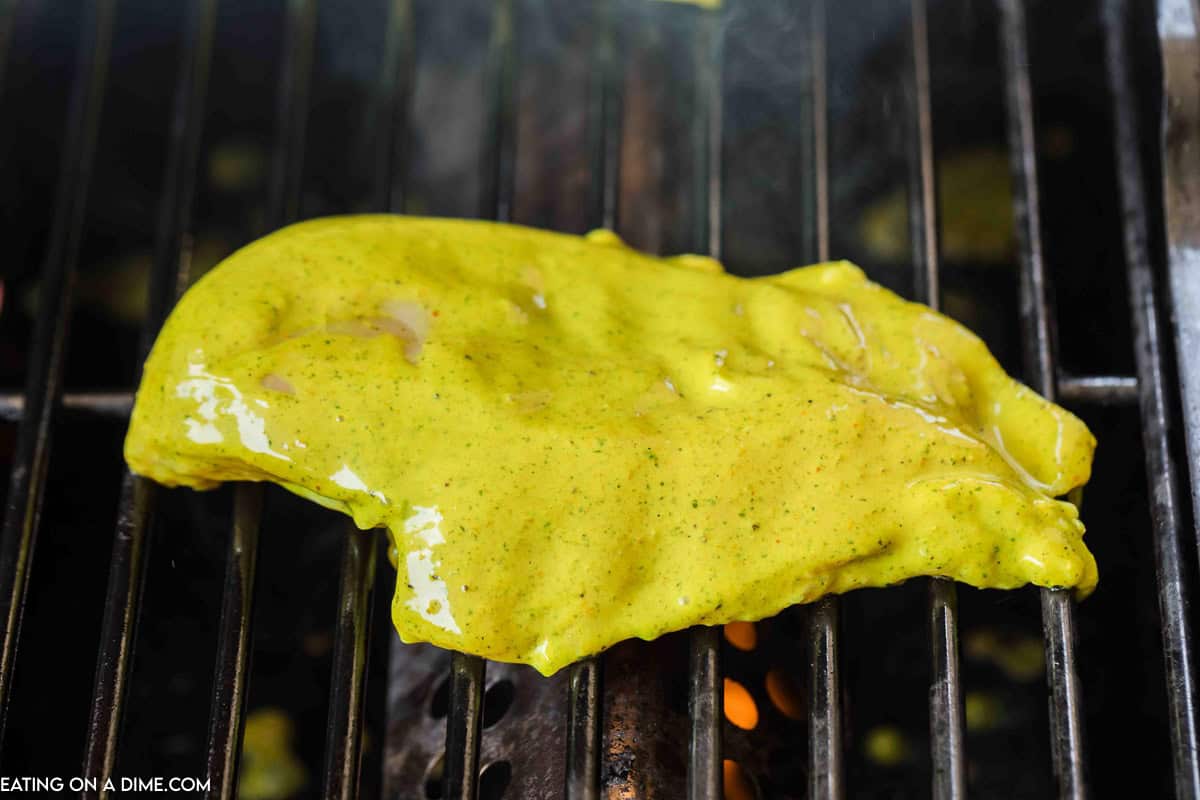 Marinated chicken breast on the grill grates