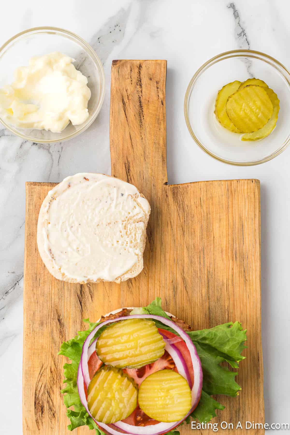 Grilled Chicken Burger on a bun topped with lettuce, tomato, red onions and pickles