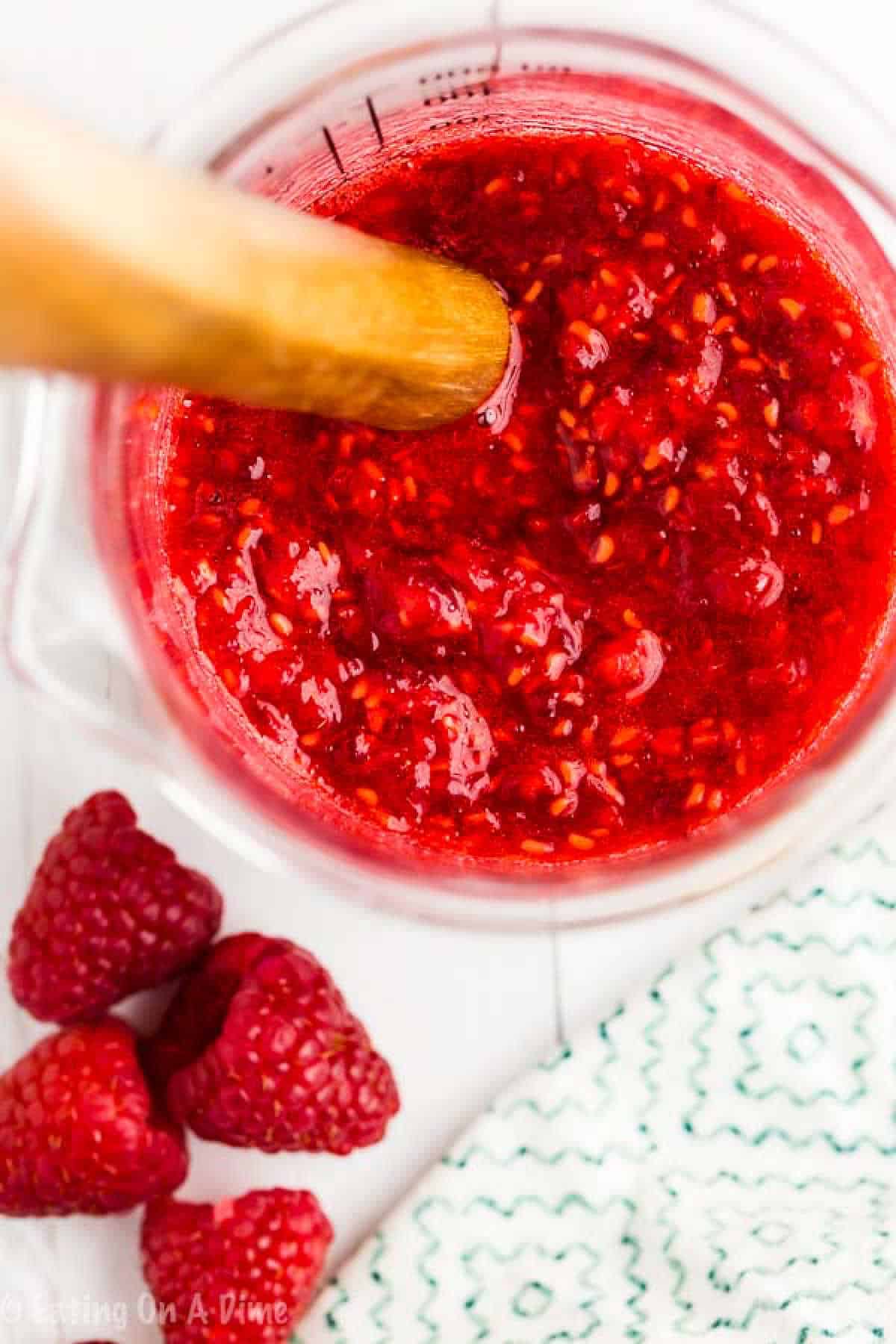 Mashing raspberries in a measuring cup