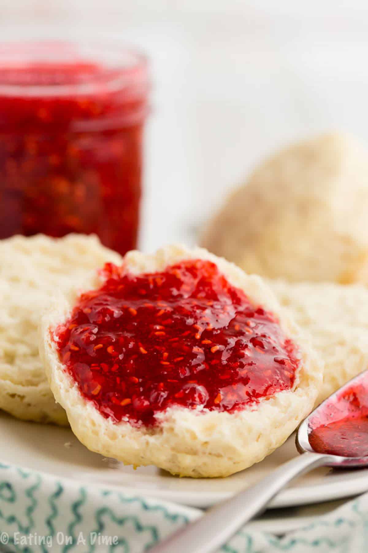 Raspberry jam spread on biscuits on a plate