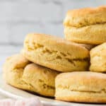 A close-up of a plate stacked with golden, flaky biscuits made using the Chick-Fil-A Biscuits Recipe, showing their layered texture and slightly crisp edges against a soft-focus background.