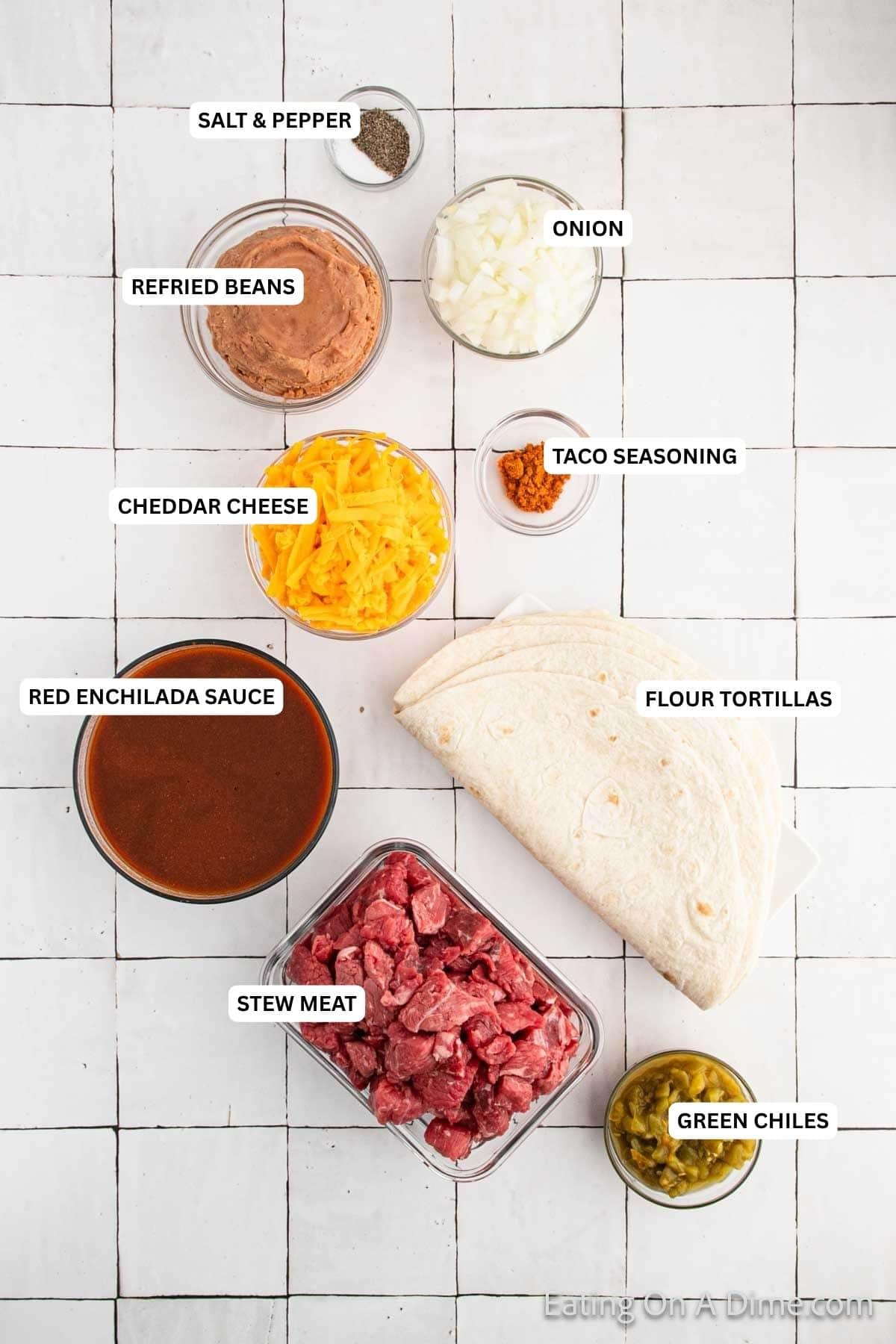 Ingredients for recipe: salt, pepper, refried beans, onion, cheese, taco seasoning, red enchilada sauce, flour tortillas, stew meat and green chiles.