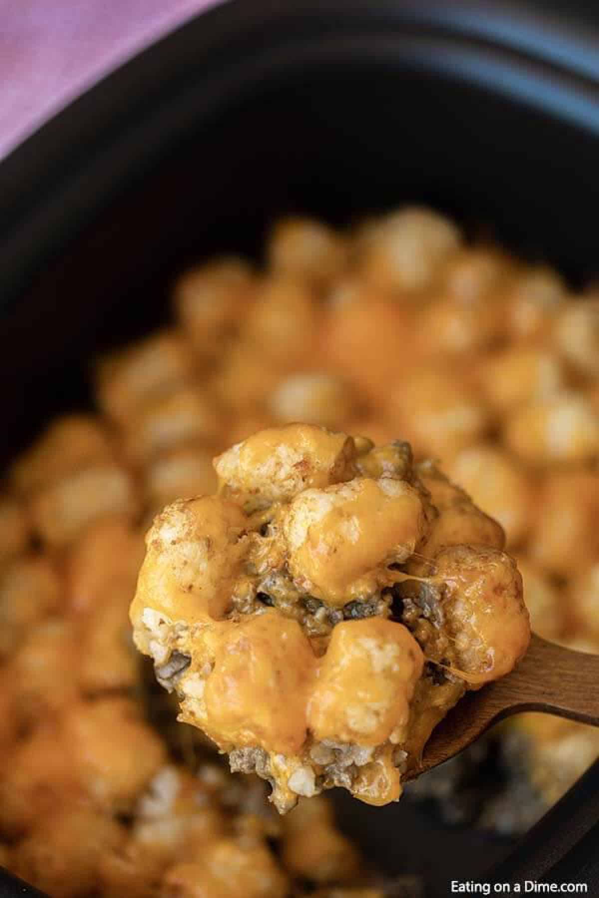 Learn how to make Crock Pot Tator Tot Casserole Recipe. Your slow cooker does all the work and you will come home to Easy Tator Tot Casserole waiting. This simple crockpot tater tot casserole with hamburger and mushroom soup is simple to make and is one of my favorite easy recipes. The entire family will love this cheesy beef tater tot casserole recipe! #eatingonadime #crockpotrecipes #dinnerrecipes #easyrecipes 