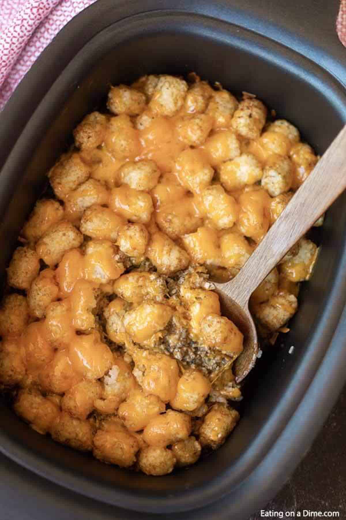 Learn how to make Crock Pot Tator Tot Casserole Recipe. Your slow cooker does all the work and you will come home to Easy Tator Tot Casserole waiting. This simple crockpot tater tot casserole with hamburger and mushroom soup is simple to make and is one of my favorite easy recipes. The entire family will love this cheesy beef tater tot casserole recipe! #eatingonadime #crockpotrecipes #dinnerrecipes #easyrecipes Learn how to make Crock Pot Tator Tot Casserole Recipe. Your slow cooker does all the work and you will come home to Easy Tator Tot Casserole waiting. This simple crockpot tater tot casserole with hamburger and mushroom soup is simple to make and is one of my favorite easy recipes. The entire family will love this cheesy beef tater tot casserole recipe! #eatingonadime #crockpotrecipes #dinnerrecipes #easyrecipes