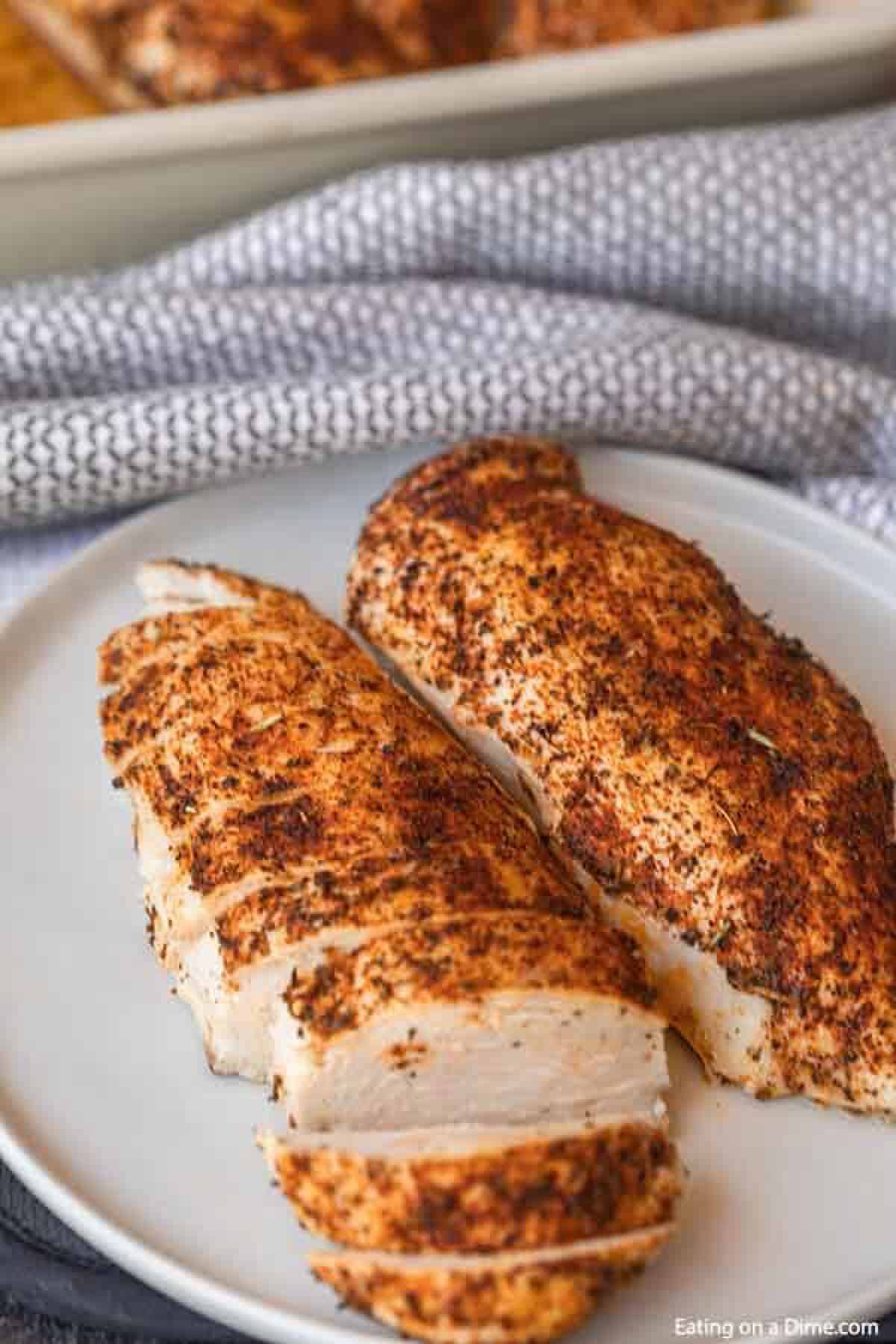 Seasoned chicken breast on a plate sliced 