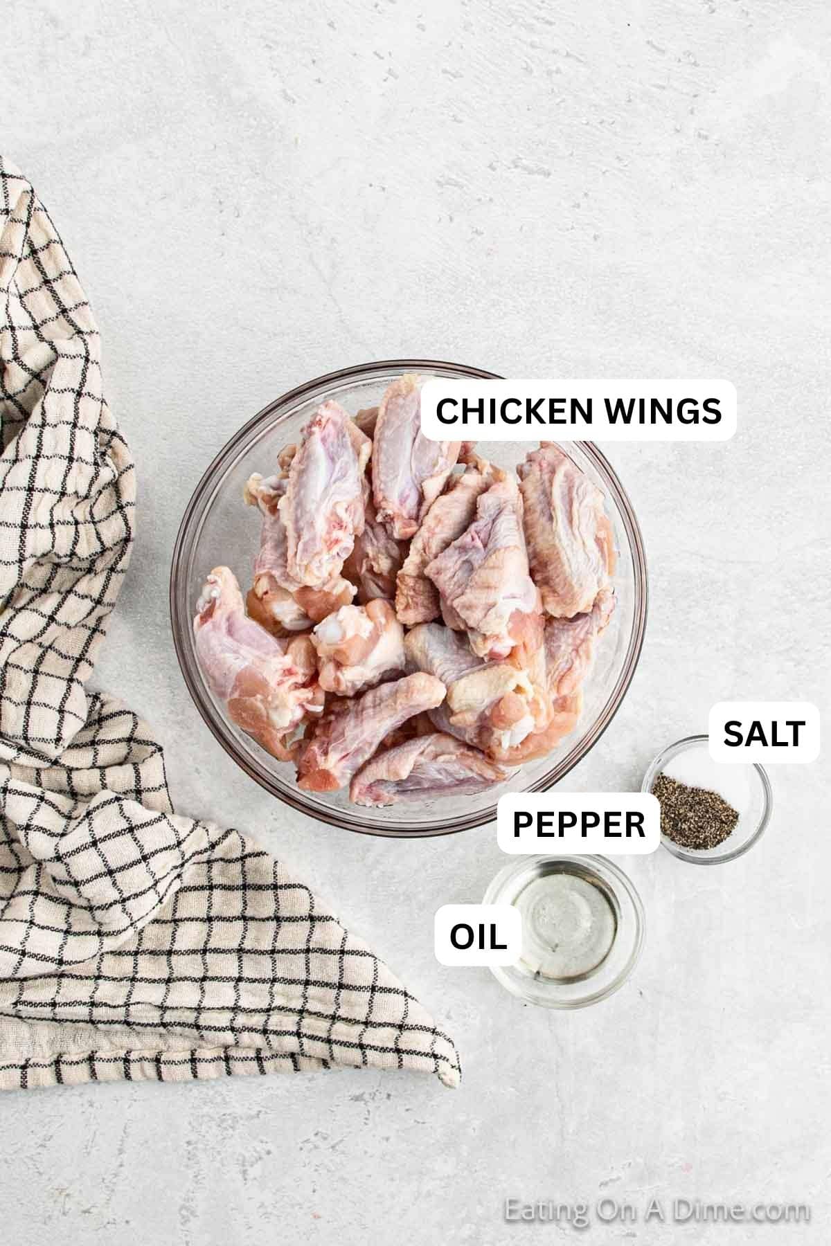 Ingredients needed to make this recipe which includes uncooked chicken wings, oil and salt and pepper.