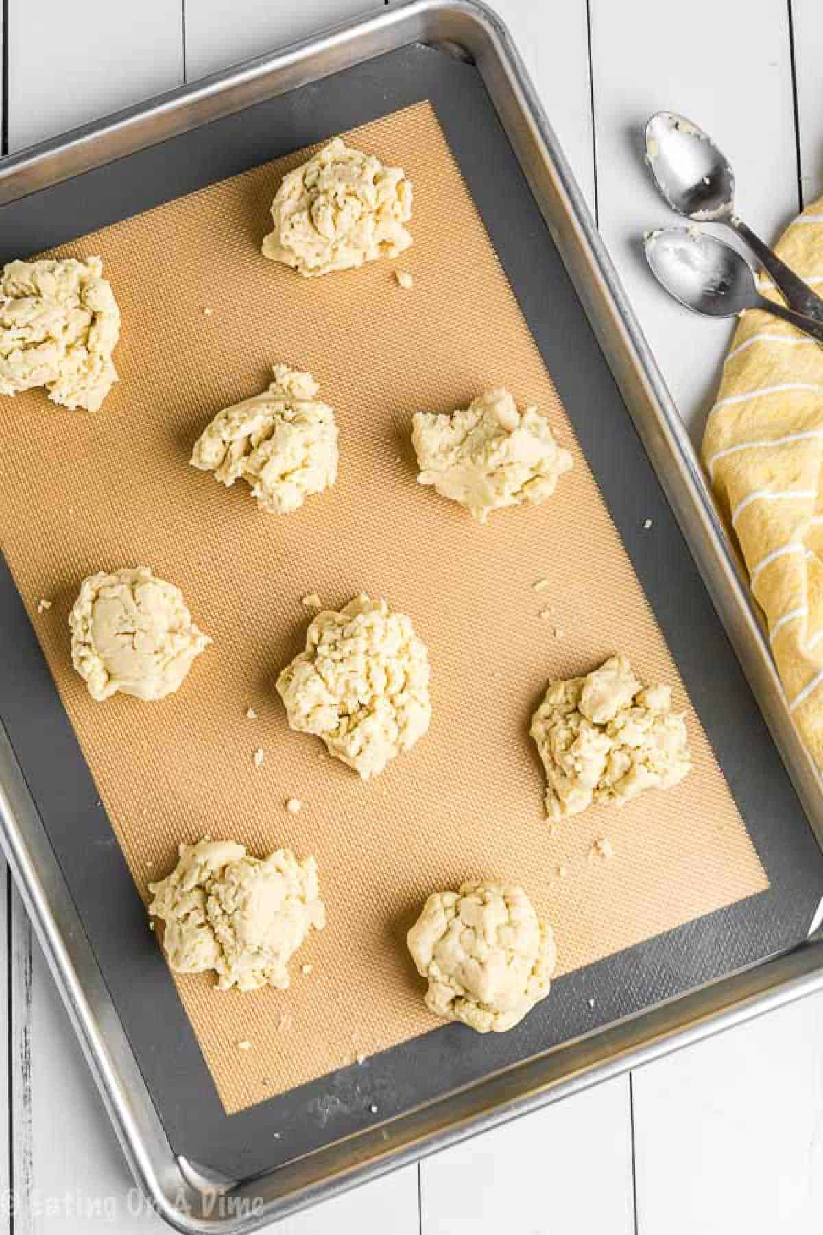 Biscuit dough on baking sheet lined with a baking mat