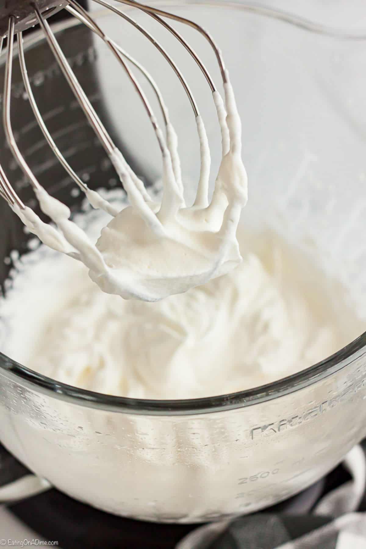 Once you learn how to make whipped cream, it is so simple and tastes much better than store bought. This whipped cream recipe is easy and tastes great! Whipped Cream in a bowl and on the beater