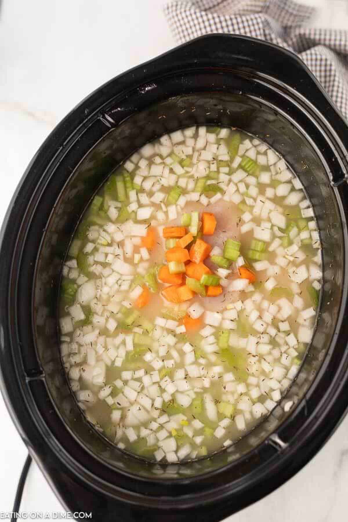 Close up image of uncooked ingredients for chicken noodle soup. 
