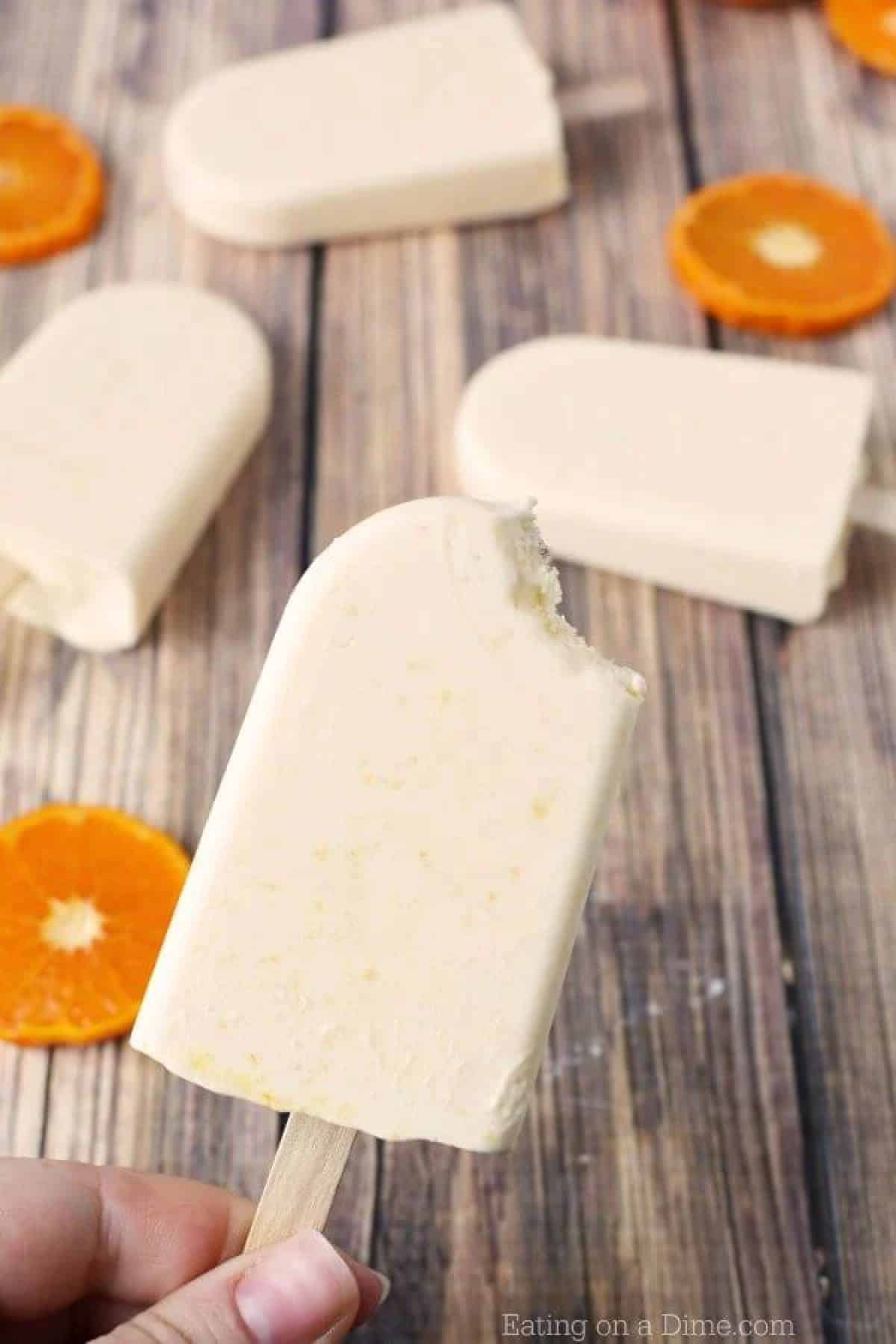 Everyone will love this Orange Creamsicle Popsicle recipe. The fresh orange and whipping cream make this orange creamsicle recipe so smooth and creamy. Try this Orange creamsicle recipe today. The kids will go crazy over it. Close up image of orange creamsicle popsicle