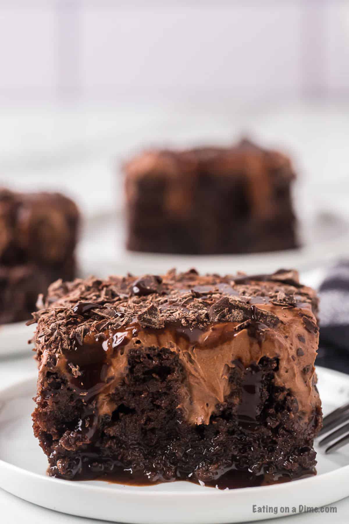 Slice of chocolate poke cake on plate.