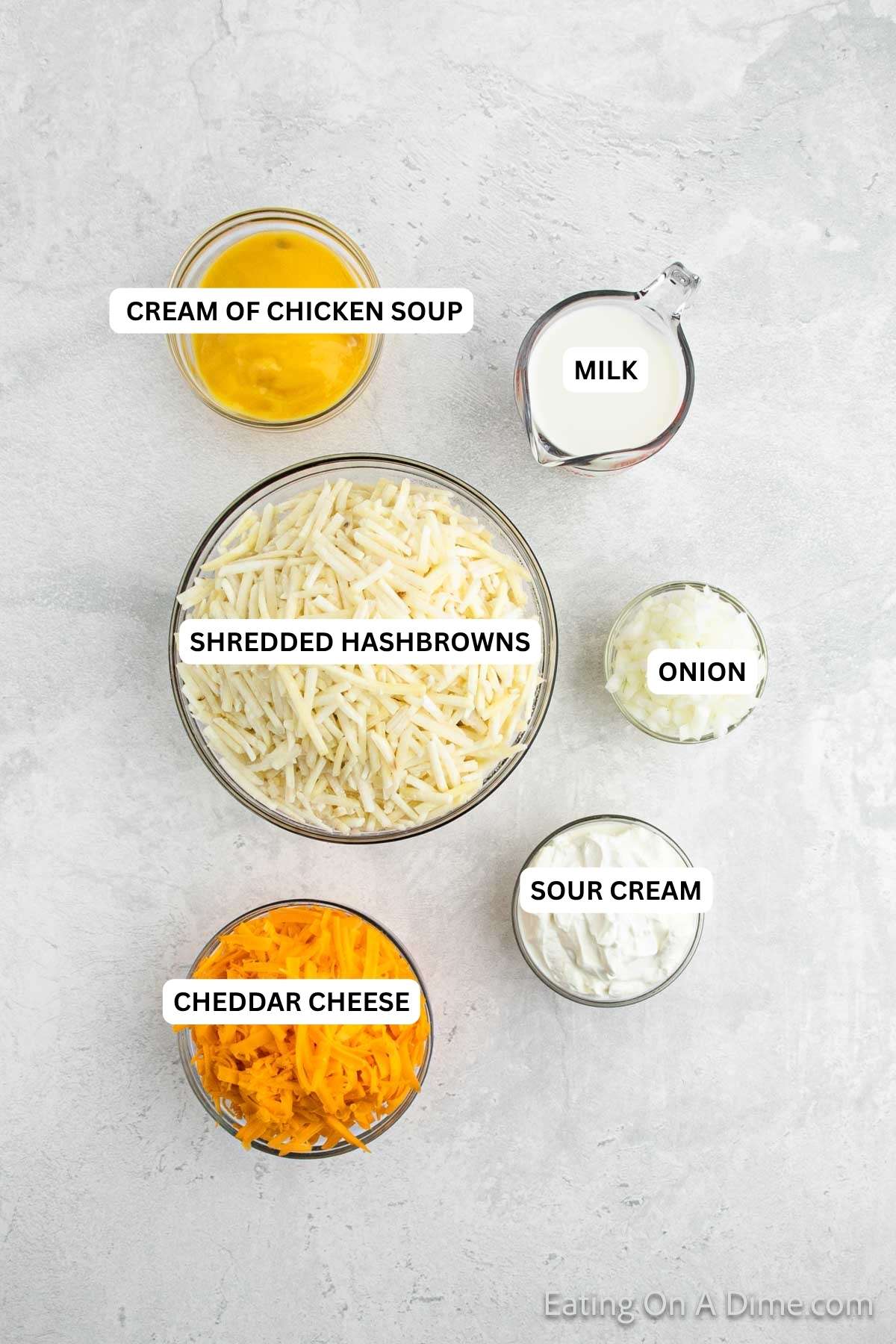 Ingredients for recipe: cream of chicken soup, milk, shredded hashbrowns, onion, sour cream and cheddar cheese.