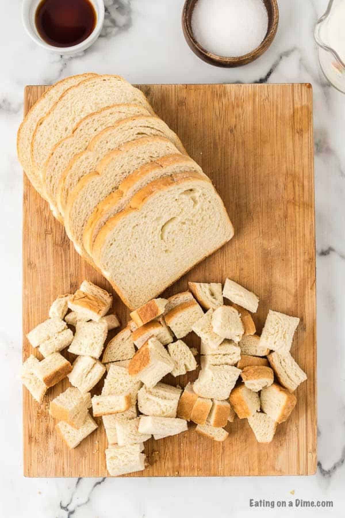 Bread Slices on a cutting board with pieces of bread on the side 