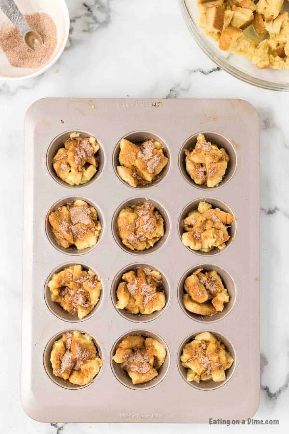 Bread pieces in the muffin cups 