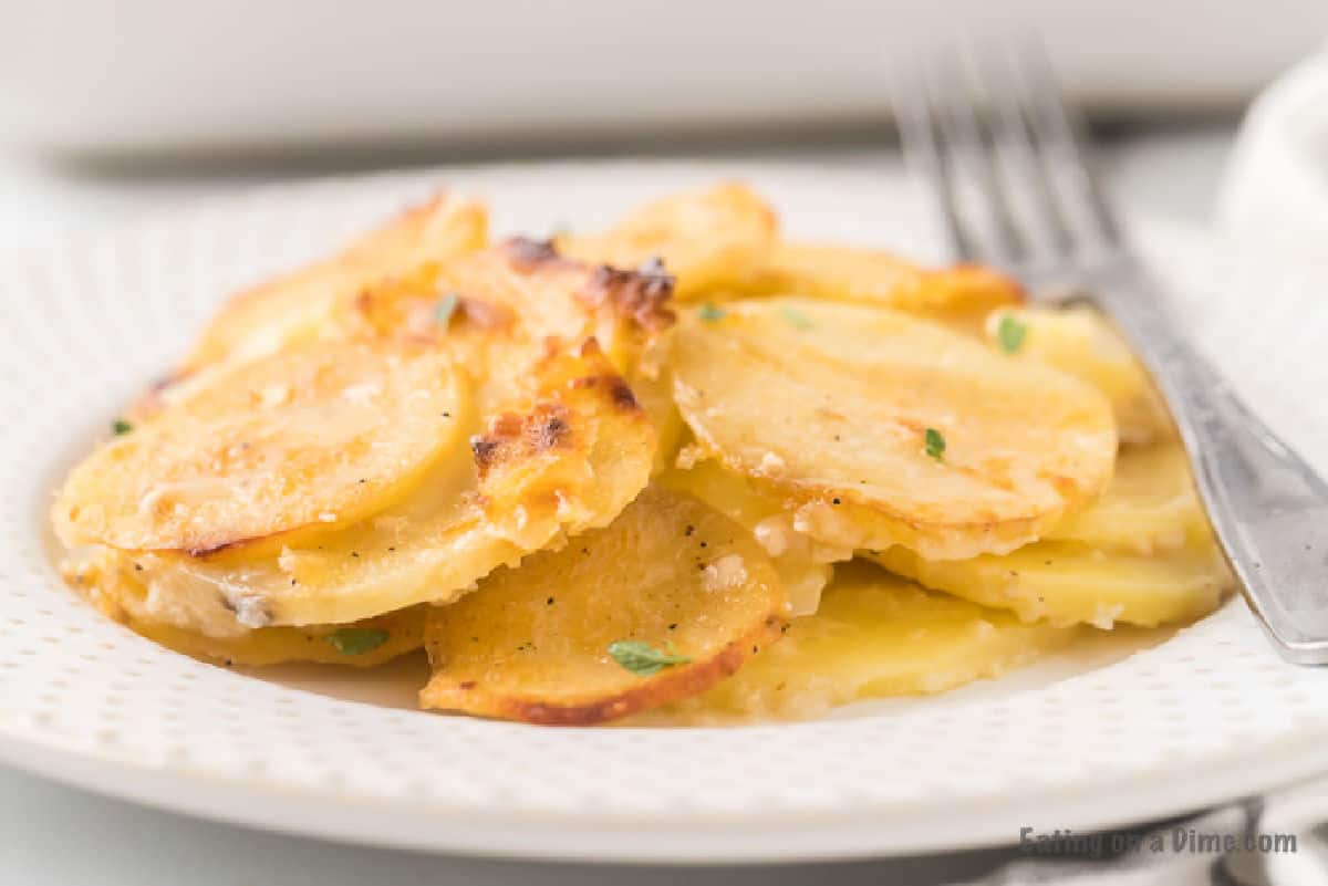 A serving of scalloped potatoes on a plate.