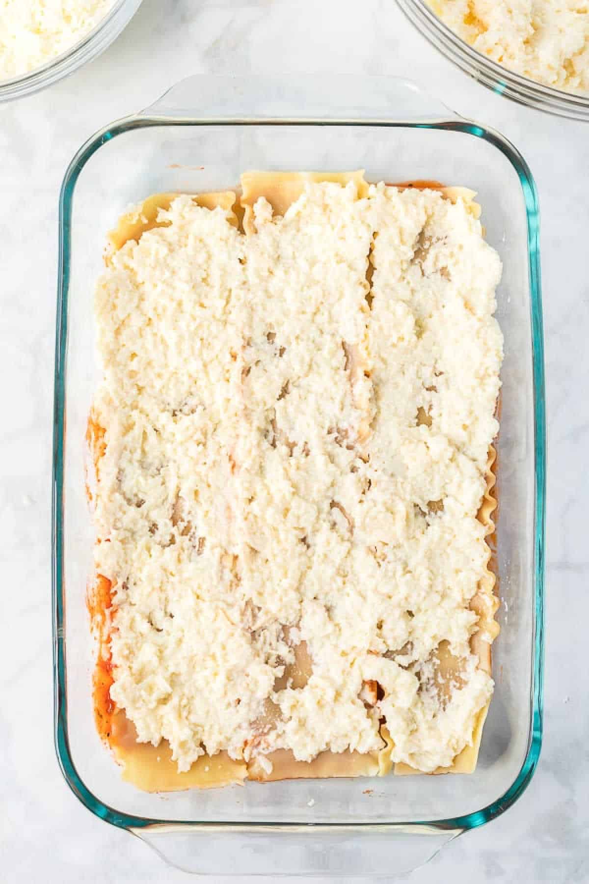 Layering noodles and cheese mixture in a baking dish