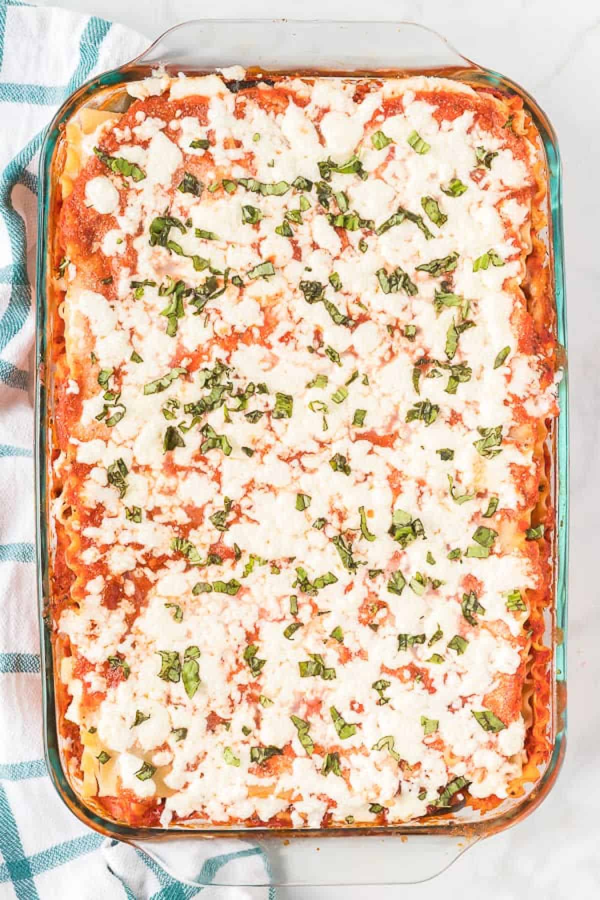 Vegetarian Lasagna in a baking dish topped with melted cheese