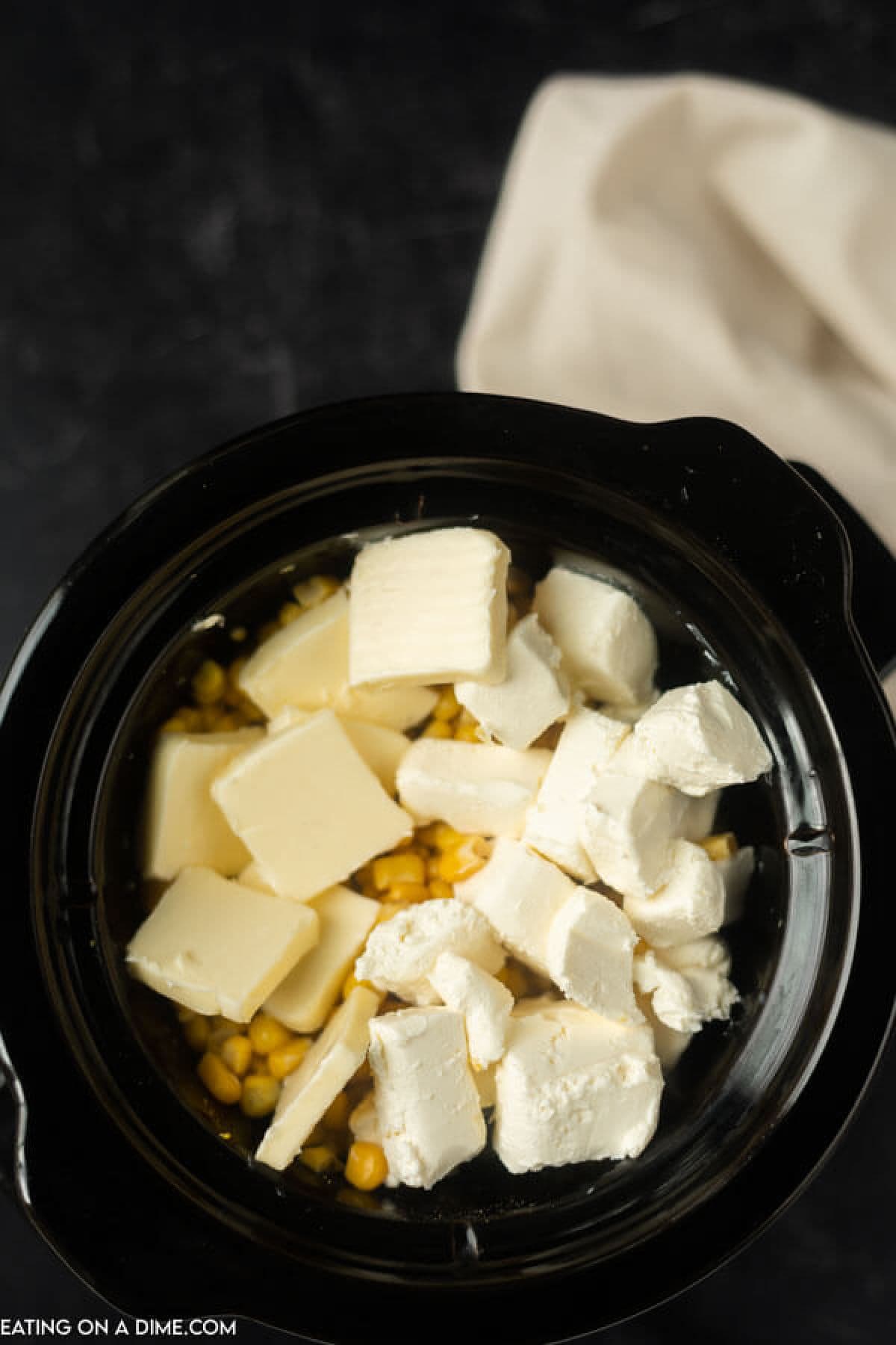 Corn in the slow cooker topped with butter and cream cheese