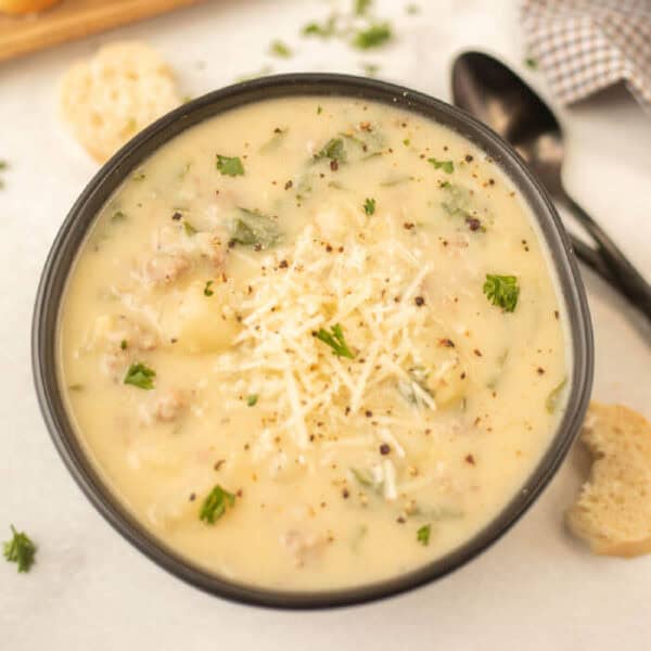 Cheesy spinach and potato soup in a bowl. Zuppa Toscana Soup in a serving bowl.