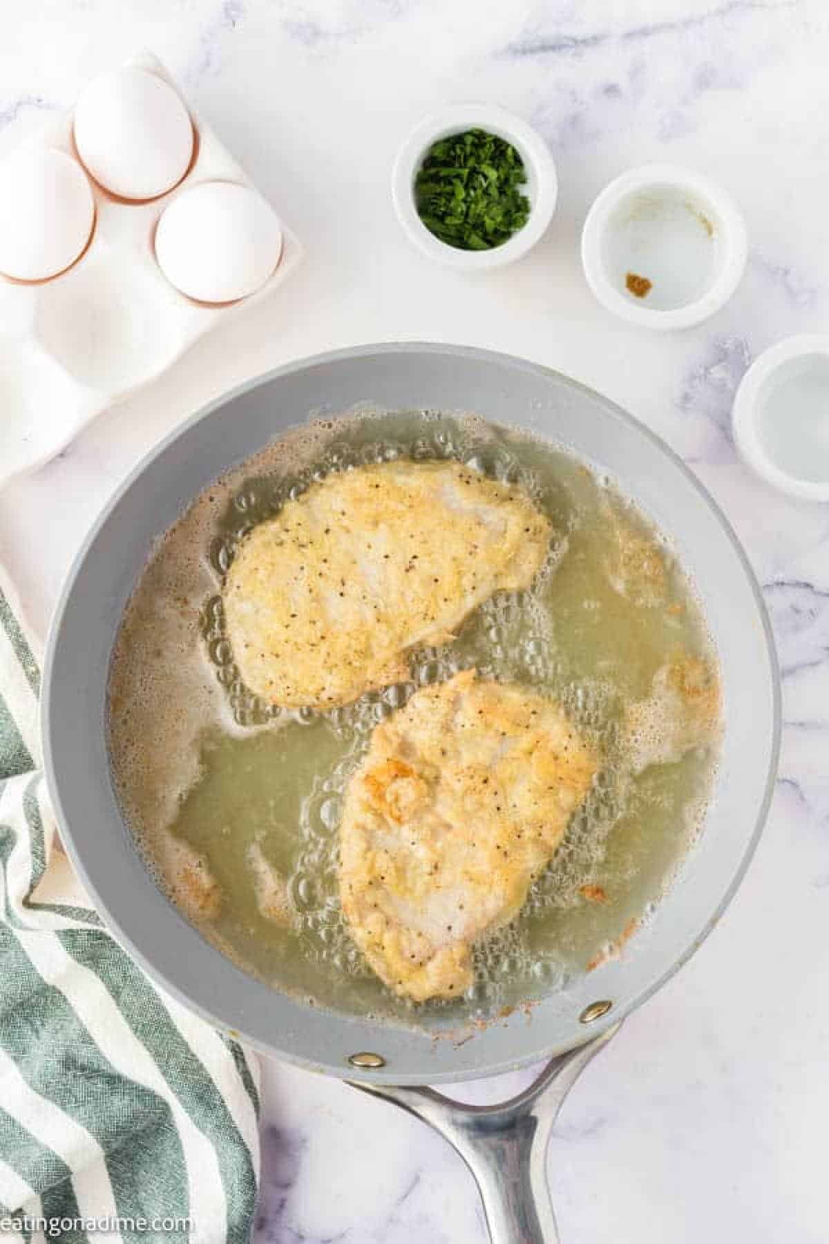 Frying pork chops in a skillet with oil