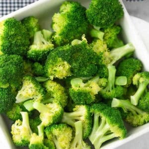 A white bowl filled with broccoli florets.