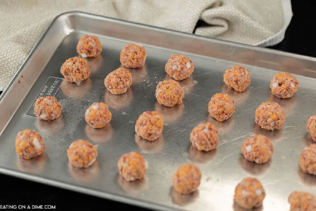 Uncooked sausage balls on a baking sheet
