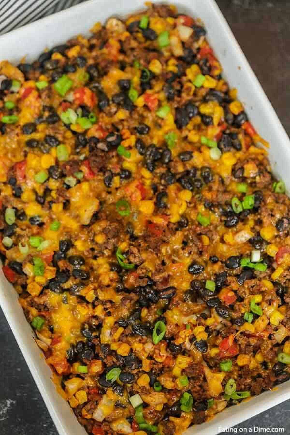 Taco rice casserole is an easy dinner idea and freezer friendly. It is a great recipe to stretch your meat and budget friendly. #eatingonadime #mexicanrecipes #casserolerecipes #recipeseasy #freezermeals