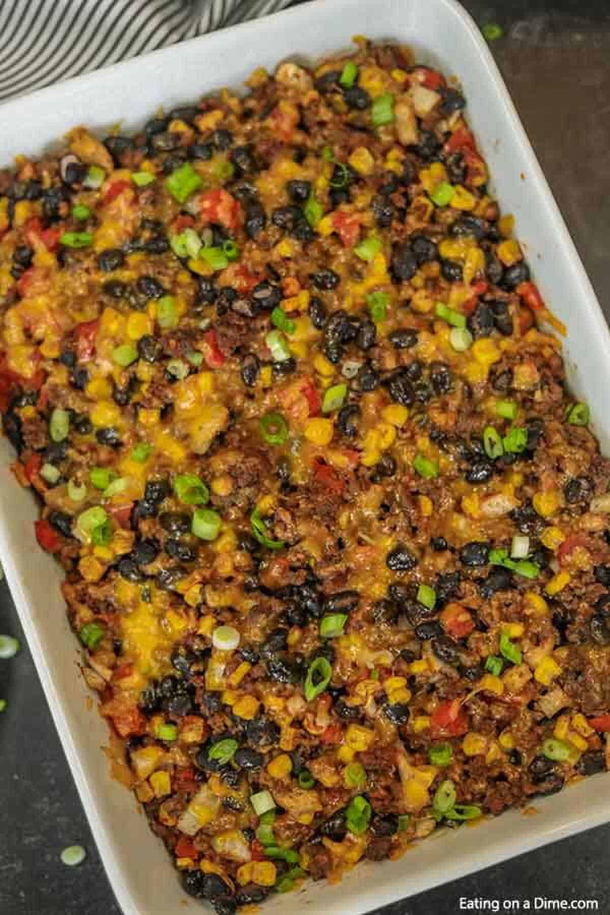Taco rice casserole is an easy dinner idea and freezer friendly. It is a great recipe to stretch your meat and budget friendly. #eatingonadime #mexicanrecipes #casserolerecipes #recipeseasy #freezermeals