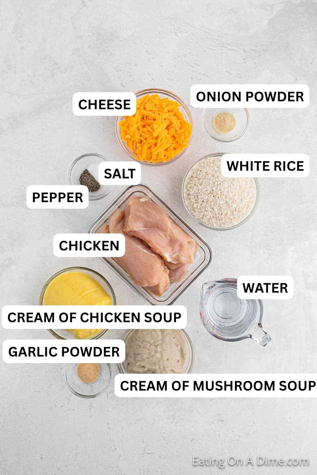 Ingredients needed to make this recipe which includes White Rice, cream of chicken soup, cream of mushroom soup, water, salt, garlic powder, onion powder, pepper, chicken breasts, and cheddar cheese.