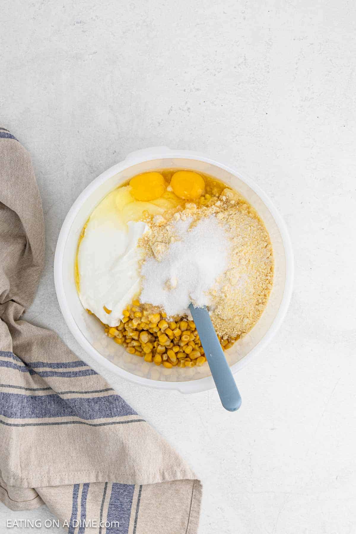 Combining all the ingredients except the cheese in a bowl.