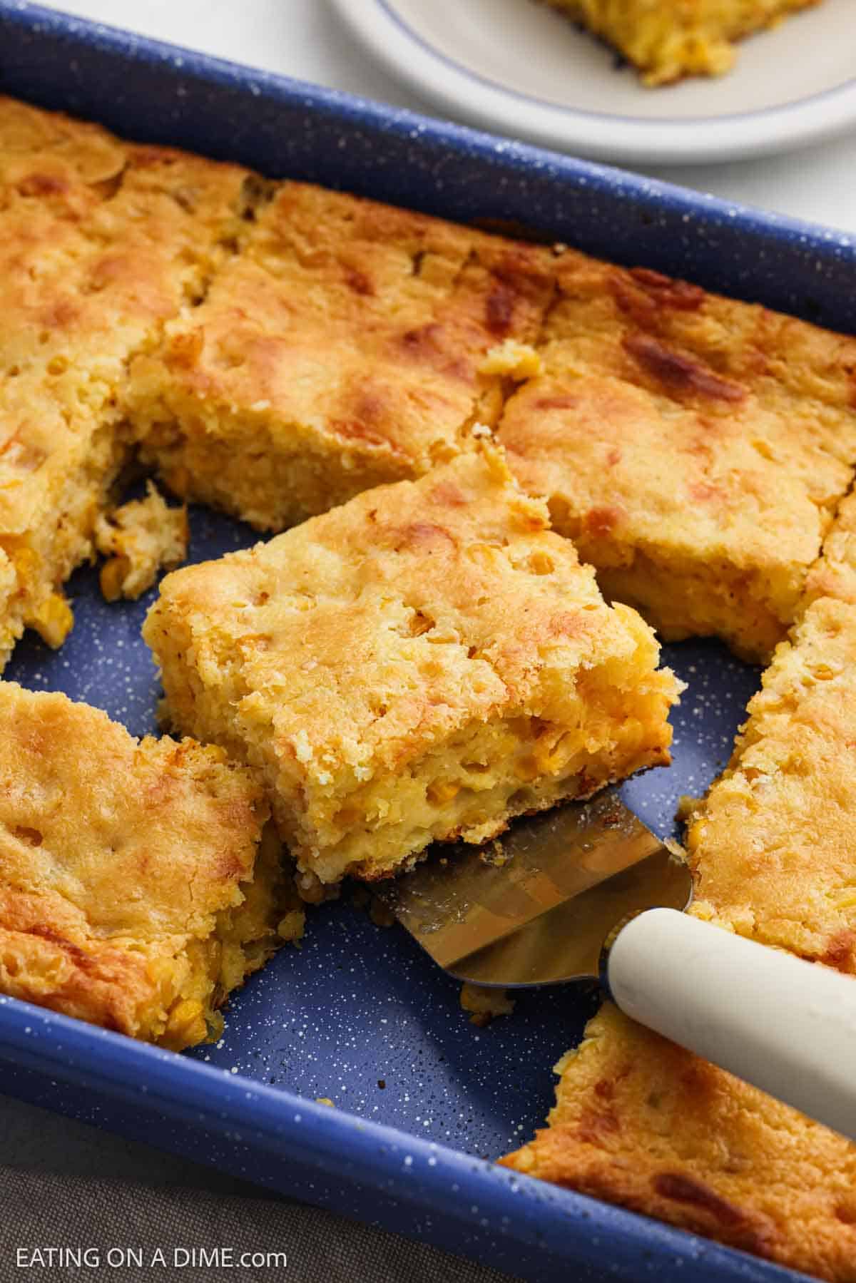 Baked cornbread casserole in a baking dish.