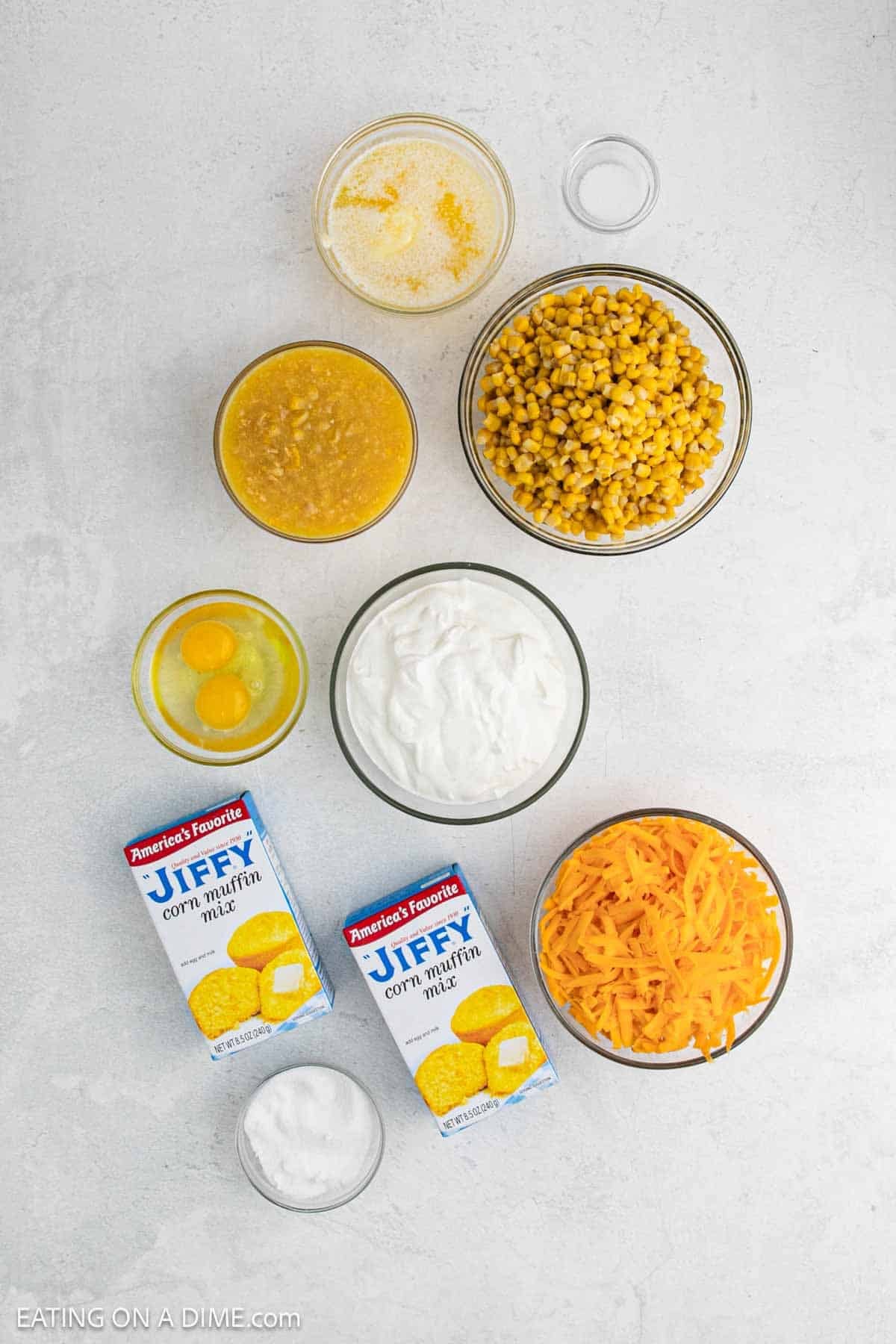 Ingredients to make this recipe includes butter, corn, sour cream, sugar. salt, jiffy muffin mix, eggs, cheese.