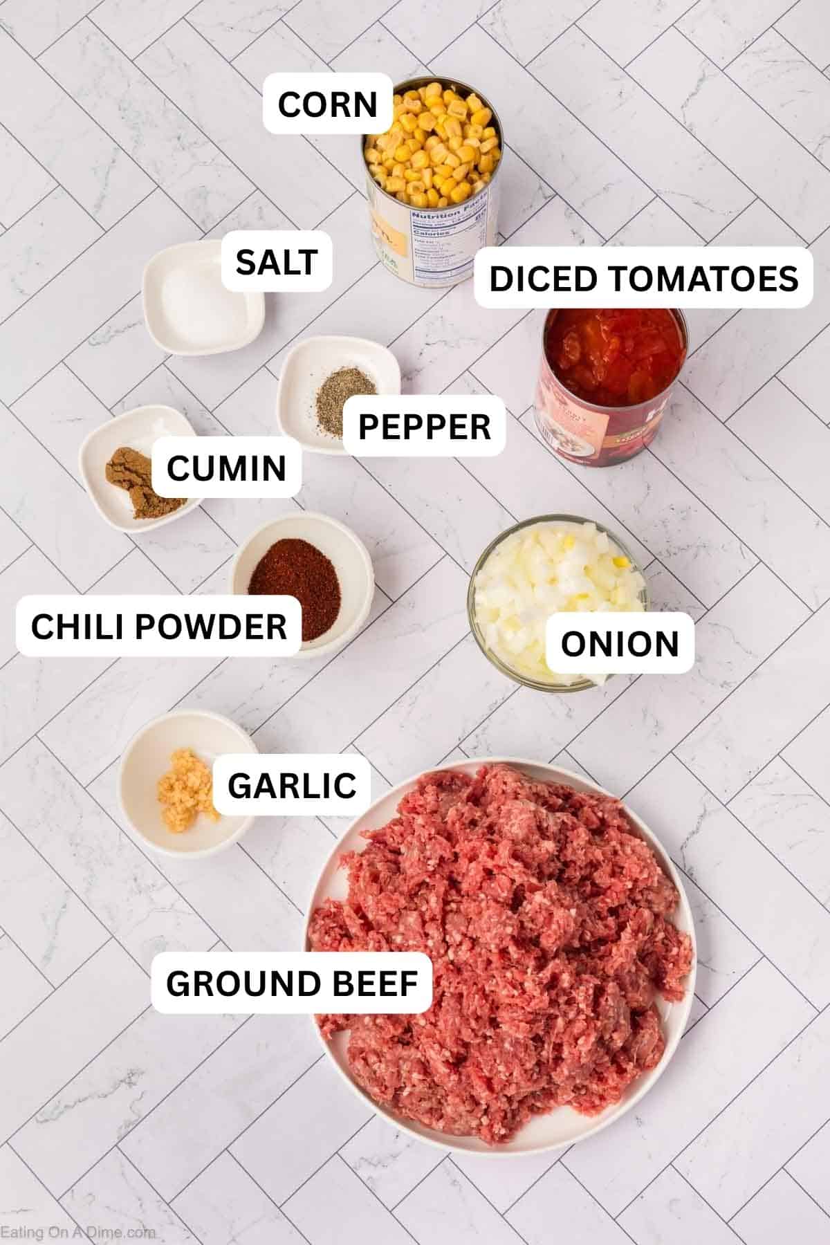 Ingredients needed to make this recipe which includes Ground beef, onion, garlic, diced tomatoes, corn, chili powder, cumin, salt, and pepper.