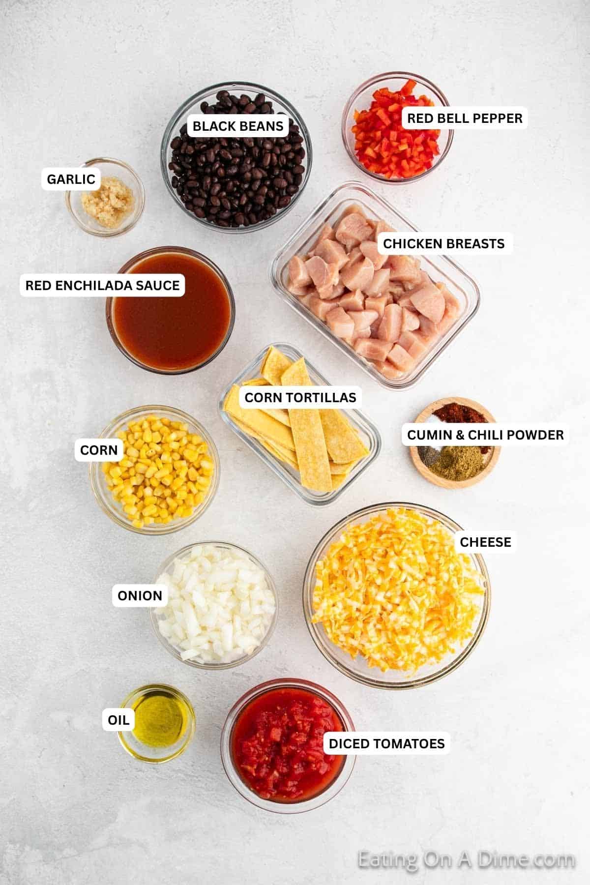 Ingredients for recipe: red bell peppers, black beans, garlic, enchilada sauce, chicken, tortillas, corn, onion, seasoning, oil, cheese and diced tomatoes.