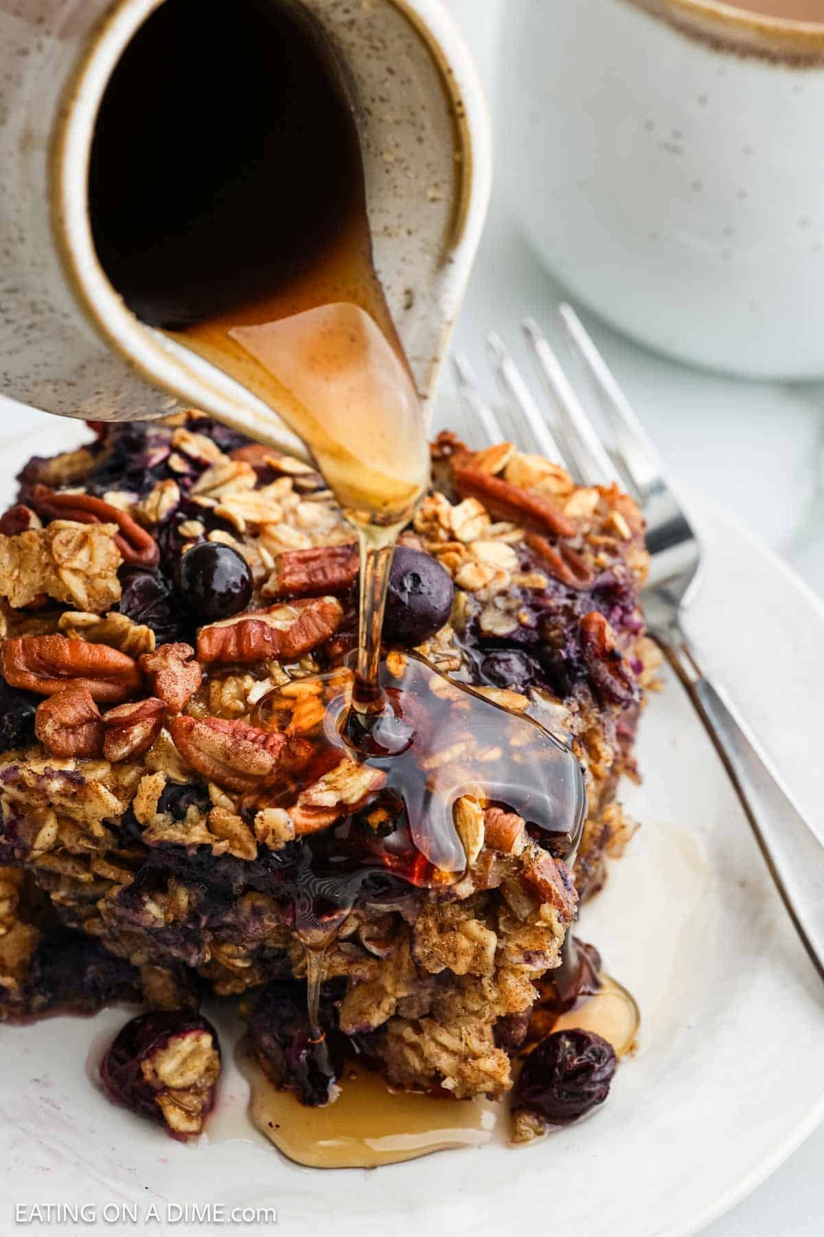 Pouring maple syrup over the top of the baked oatmeal