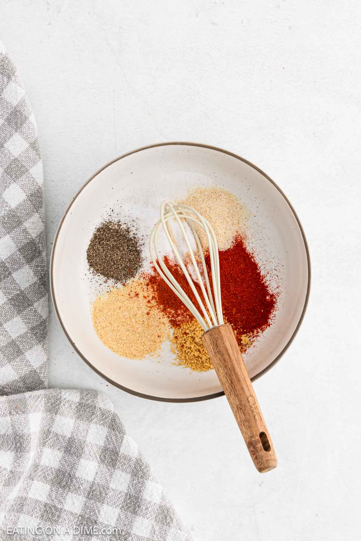 Combine the seasoning in a bowl with a whisk