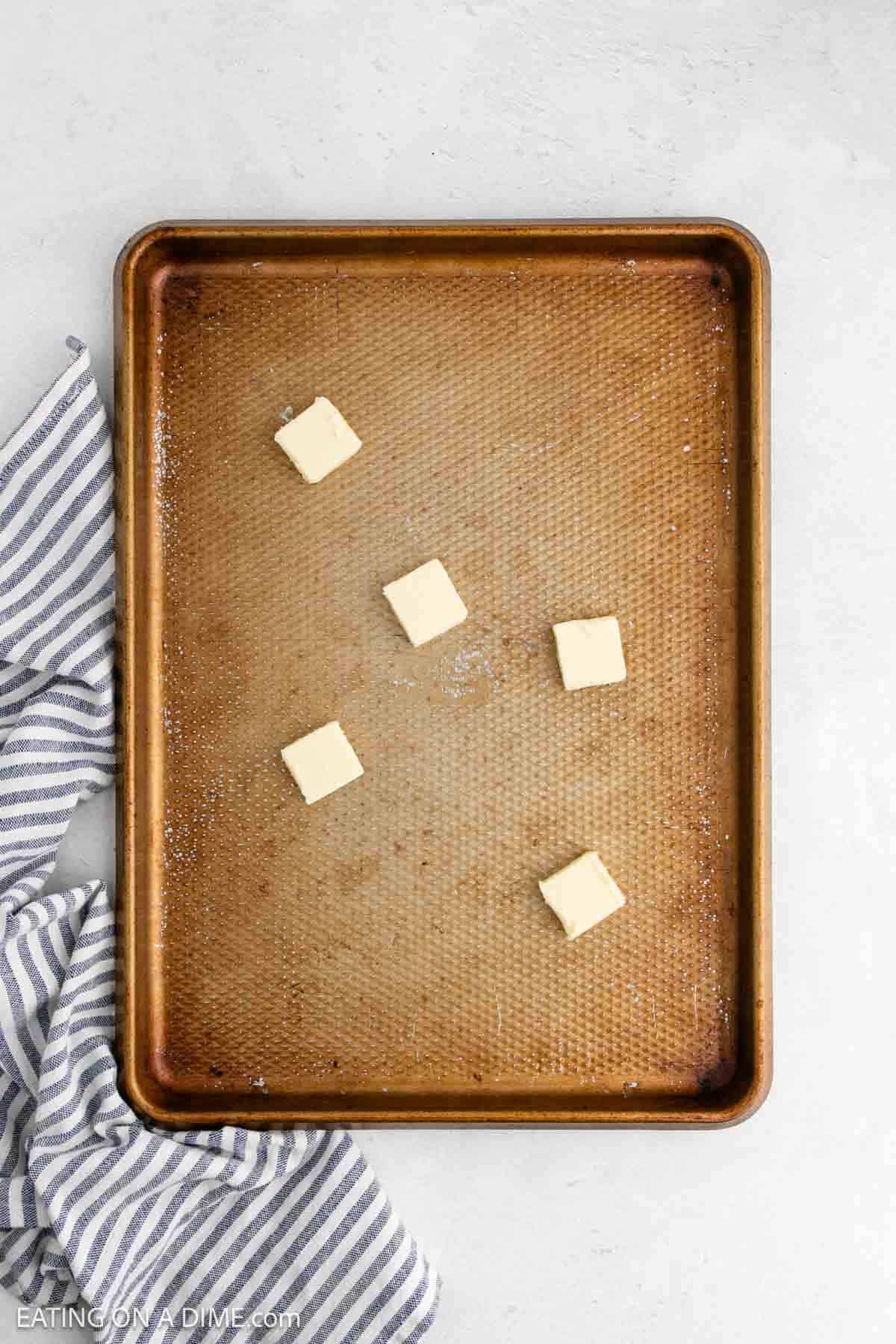 Butter slices on a baking sheet