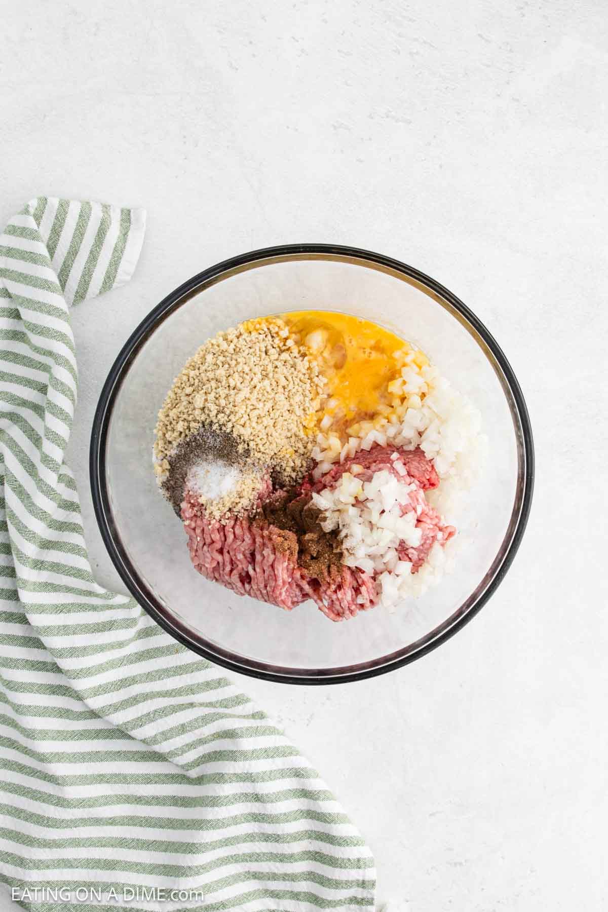 Combining the meatballs ingredients in a bowl