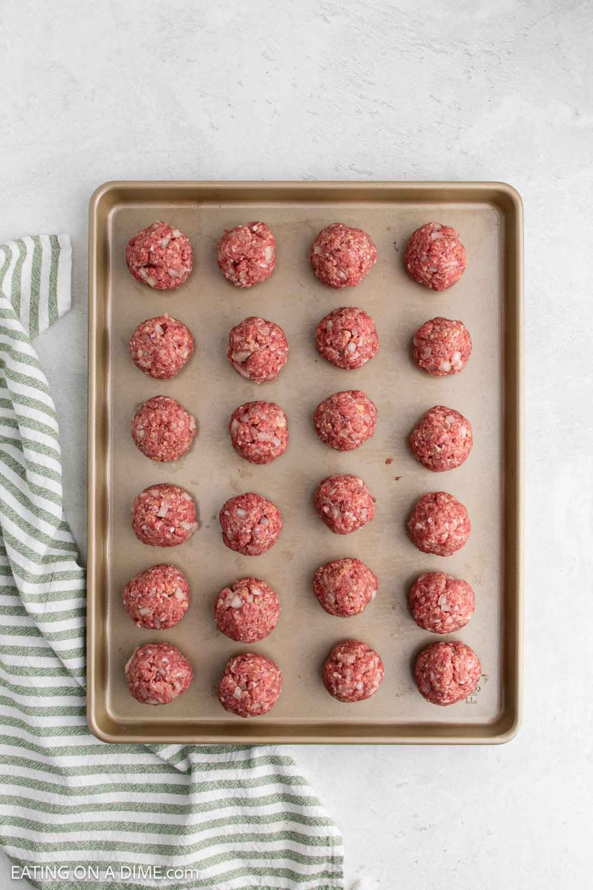 Uncooked meatballs on a baking sheet