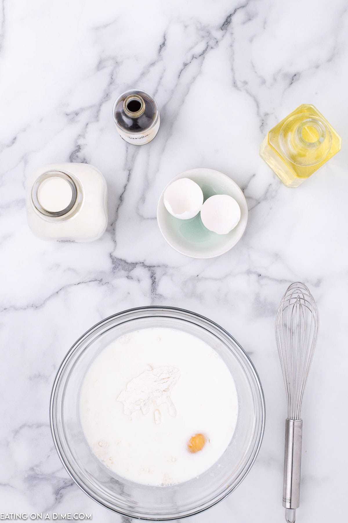 Pancake mix, milk, egg, oil combined in a bowl 