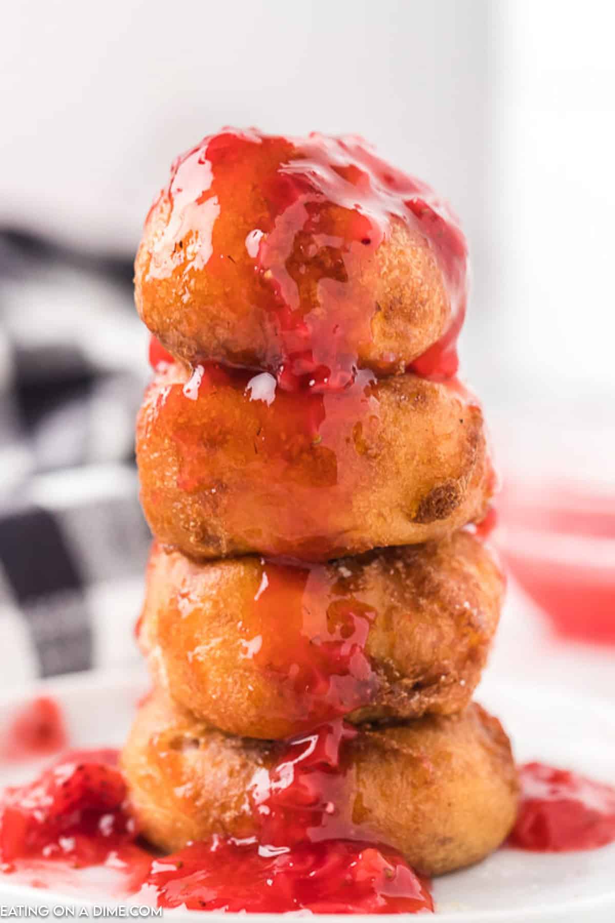 Fried Cheesecake stacked topped with strawberry sauce