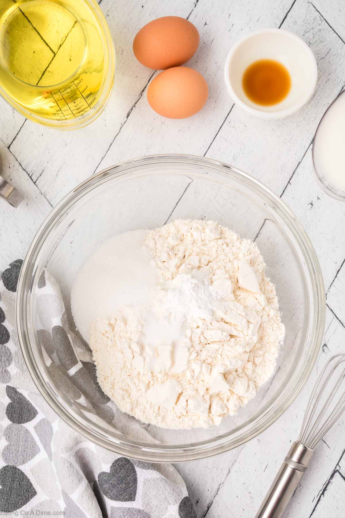 Combining the flour, sugar, and baking soda together in a bowl